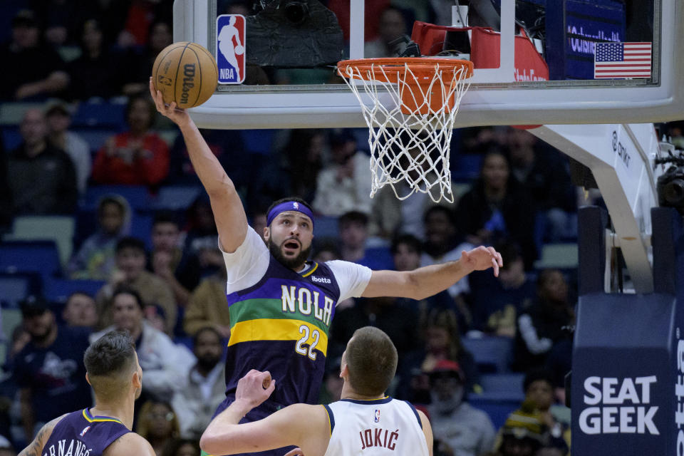 New Orleans Pelicans forward Larry Nance Jr. (22) shoots over Denver Nuggets center Nikola Jokic in the second half of an NBA basketball game in New Orleans, Tuesday, Jan. 24, 2023. (AP Photo/Matthew Hinton)