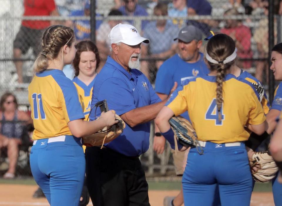 Fort Mill High School softball coach Chuck Stegall talks to his team between innings.