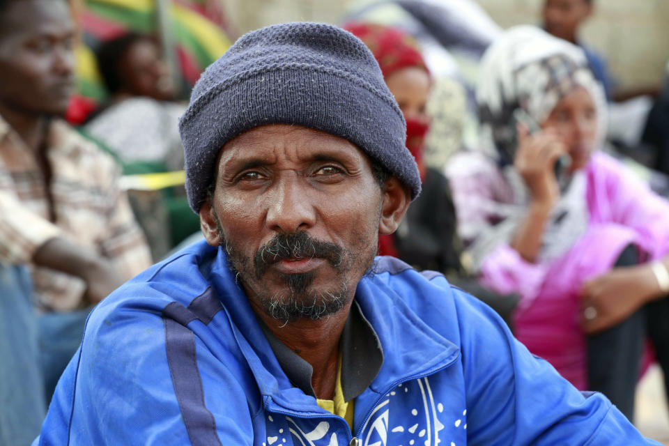 A migrant joins others in protest, Saturday, Oct. 9, 2021, in front of the office of the United Nation’s humanitarian body in Tripoli, Libya. The demonstration comes after U.N. officials said on the same day that guards at a Libyan detention center for migrants shot and killed at least six people amid chaos in the overcrowded facility. (AP Photo/Yousef Murad)