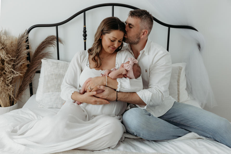 Emma Belle and her husband Gareth with their baby girl, who is now a year old. (Supplied)