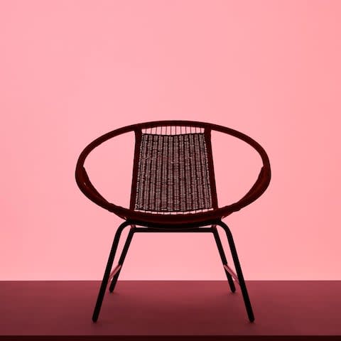 A rounded rattan Gagnet armchair with splayed legs 