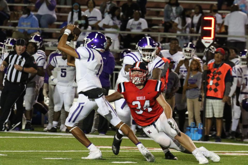 Brock Harvey (34) sacks Woodlawn-Baton Rouge quarterback Rickie Collins (1) in West Monroe's 27-0 win on Friday night at Rebel Stadium.