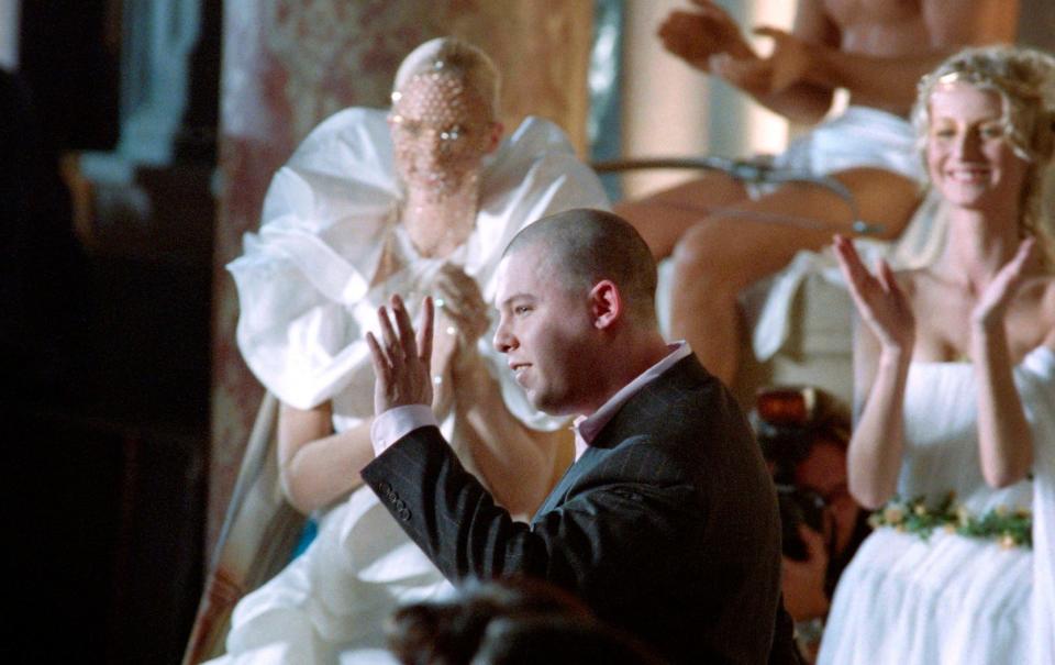 McQueen is applauded at the end of the presentation of his s/s collection for Givenchy in 1997 in Paris - AFP