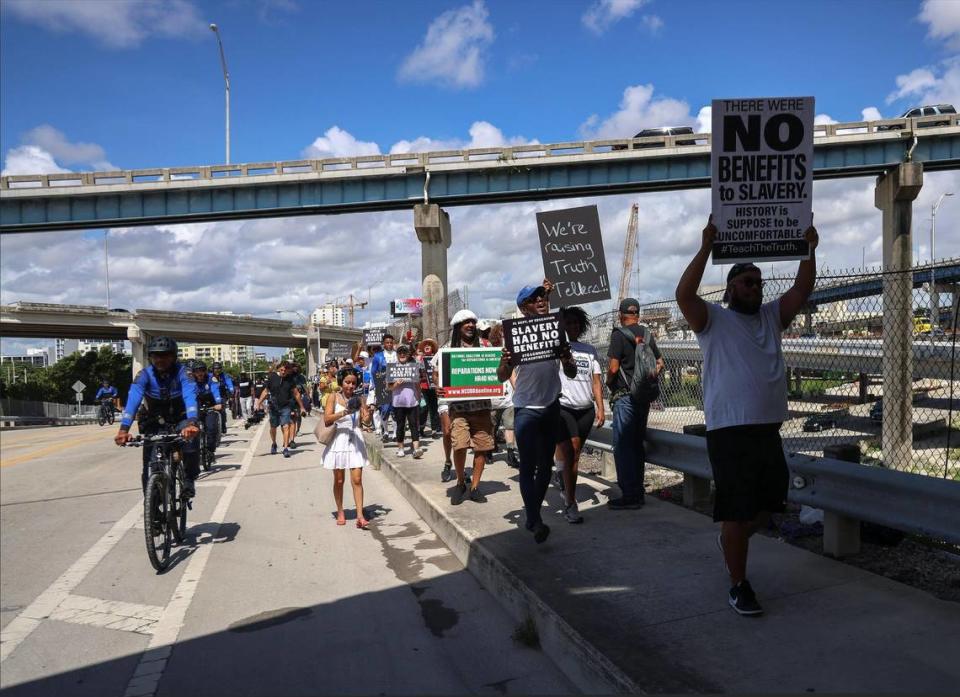 A group of roughly 80 protesters march over NW 14 Street overpass after leaving Booker T. Washington Sr. High School heading towards the MDCPS administration building in protest of the new African American history standards approved by the state in July, Wednesday, Aug. 16, 2023 in Miami, Florida.