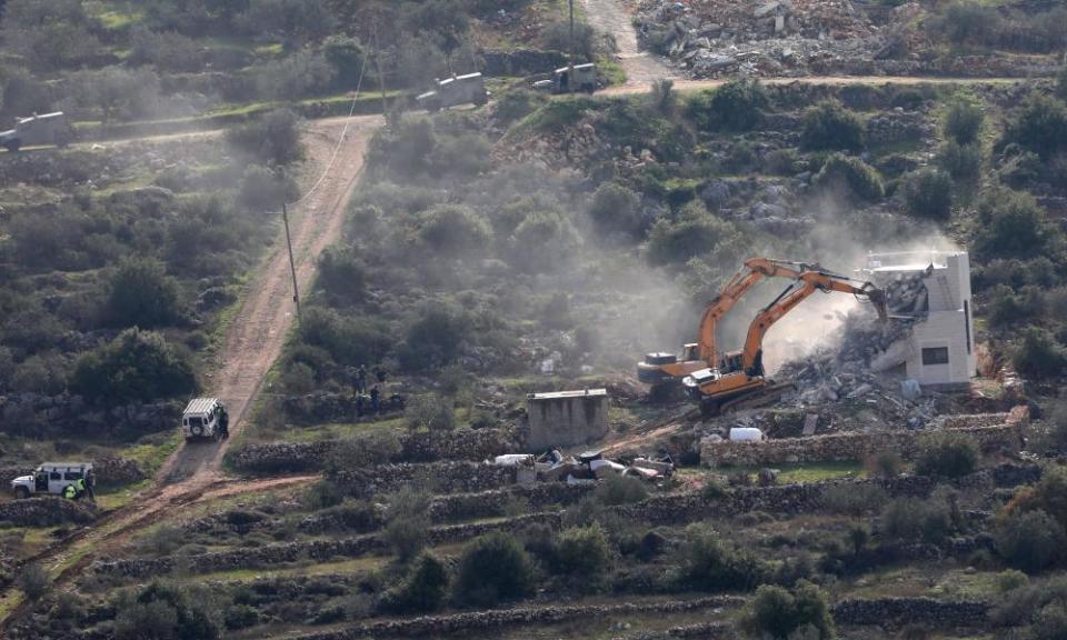 Israeli bulldozers demolish a Palestinian house in the village of Kafr al-Dik near the West Bank city of Salfit on Tuesday.