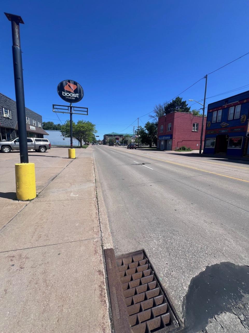 The small parking lot off Richmond Street, between College Avenue and Franklin Street in Appleton, Wis., has no marked division between it and the sidewalk, leading some drivers to cross into the sidewalk while trying to park.