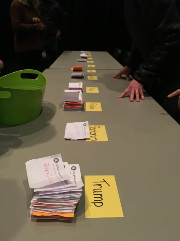 Iowa election workers table ballots as the first poll numbers are counted at a caucus in West Des Moines, on February 1, 2016