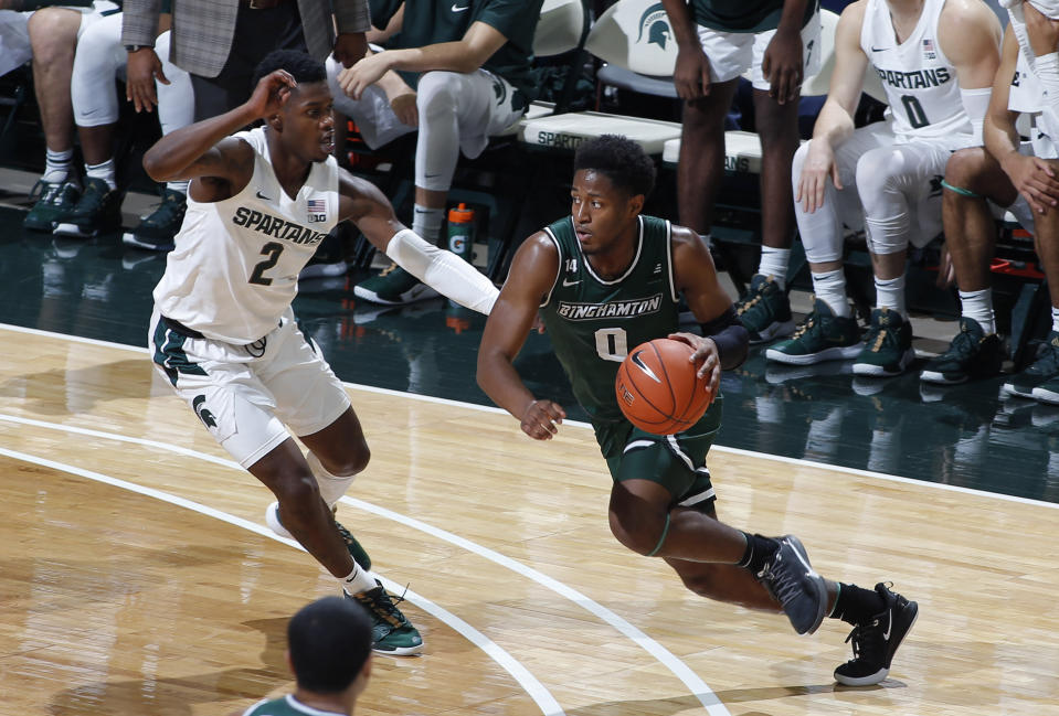 Binghamton's Richard Caldwell Jr., right, drives against Michigan State's Rocket Watts during the first half of an NCAA college basketball game, Sunday, Nov. 10, 2019, in East Lansing, Mich. (AP Photo/Al Goldis)