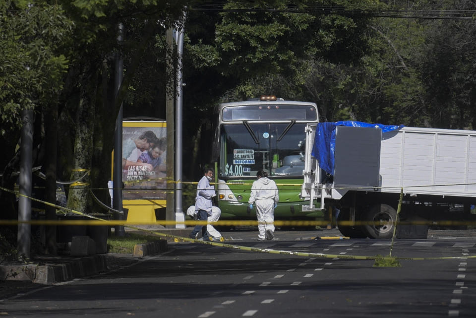 Experts work at the crime scene after Mexico City's Public Security Secretary Omar Garcia Harfuch was wounded in an attack in Mexico City, on June 26, 2020. - Mexico City's security chief was wounded in a gun attack Friday in which two of his bodyguards and a woman passerby were killed, Mayor Claudia Sheinbaum said. (Photo by PEDRO PARDO / AFP) (Photo by PEDRO PARDO/AFP via Getty Images)