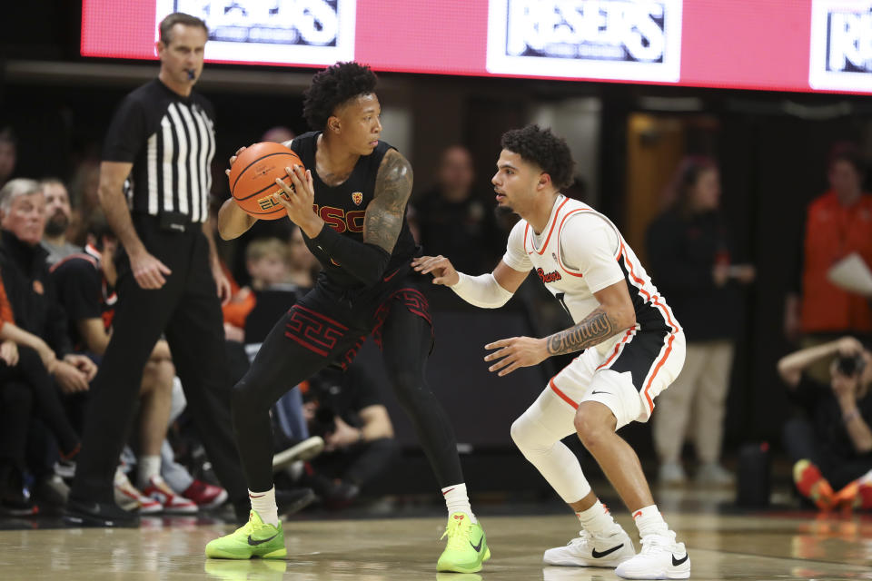 Southern California guard Boogie Ellis, left, is defended by Oregon State guard Jordan Pope during the first half of an NCAA college basketball game Saturday, Dec. 30, 2023, in Corvallis, Ore. (AP Photo/Amanda Loman)