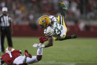 Green Bay Packers running back Aaron Jones (33) falls forward over San Francisco 49ers cornerback Jimmie Ward (1) during the second half of an NFL football game in Santa Clara, Calif., Sunday, Sept. 26, 2021. (AP Photo/Jed Jacobsohn)