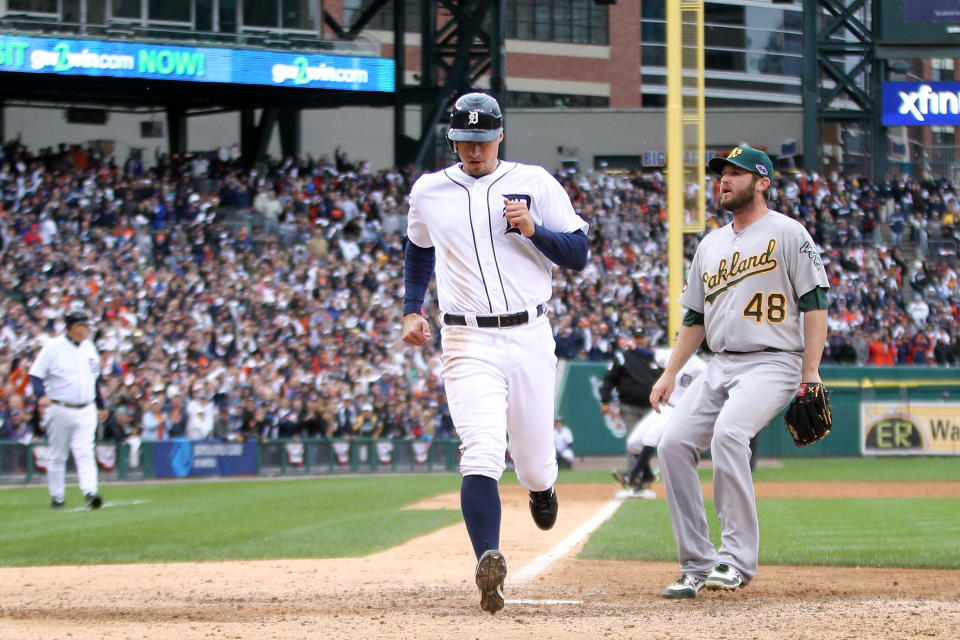 Don Kelly #32 of the Detroit Tigers scores on a wild pitch thrown by Ryan Cook #48 of the Oakland Athletics in the bottom of the eighth inning during Game Two of the American League Division Series at Comerica Park on October 7, 2012 in Detroit, Michigan. (Photo by Leon Halip/Getty Images)