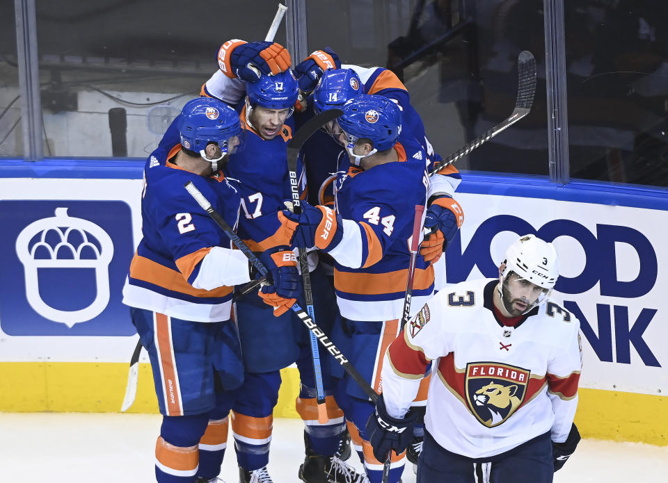 New York Islanders left wing Matt Martin (17) celebrates his goal with teammates as Florida Panthers defenceman Keith Yandle (3) skates away during the second period of an NHL Stanley Cup playoff hockey game in Toronto, Tuesday, Aug. 4, 2020. (Nathan Denette/The Canadian Press via AP)