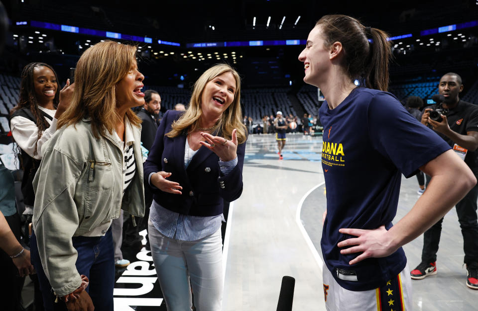 Hoda Kotb and Jeanna Bush Hager talk to Indiana Fever guard Caitlin Clark before the start of WNBA basketball game against the New York Liberty, Saturday, May 18, 2024, in New York. (AP Photo/Noah K. Murray)