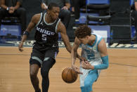 Sacramento Kings guard De'Aaron Fox (5) strips the ball from Charlotte Hornets guard LaMelo Ball (2) during the first quarter of an NBA basketball game in Sacramento, Calif., Sunday, Feb. 28, 2021. (AP Photo/Randall Benton)