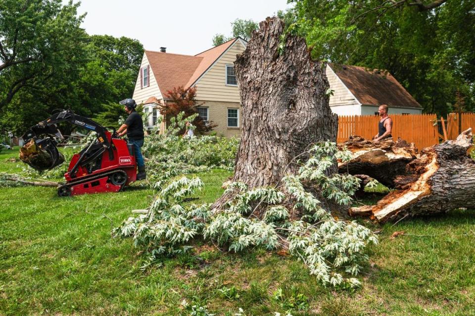 Clean up crews with Midwest Tree remove a fallen silver maple tree from a yard on Saturday, July 15, 2023, in Overland Park. As of 1:30 p.m., just under 65,000 residents in the Kansas City area were without power.