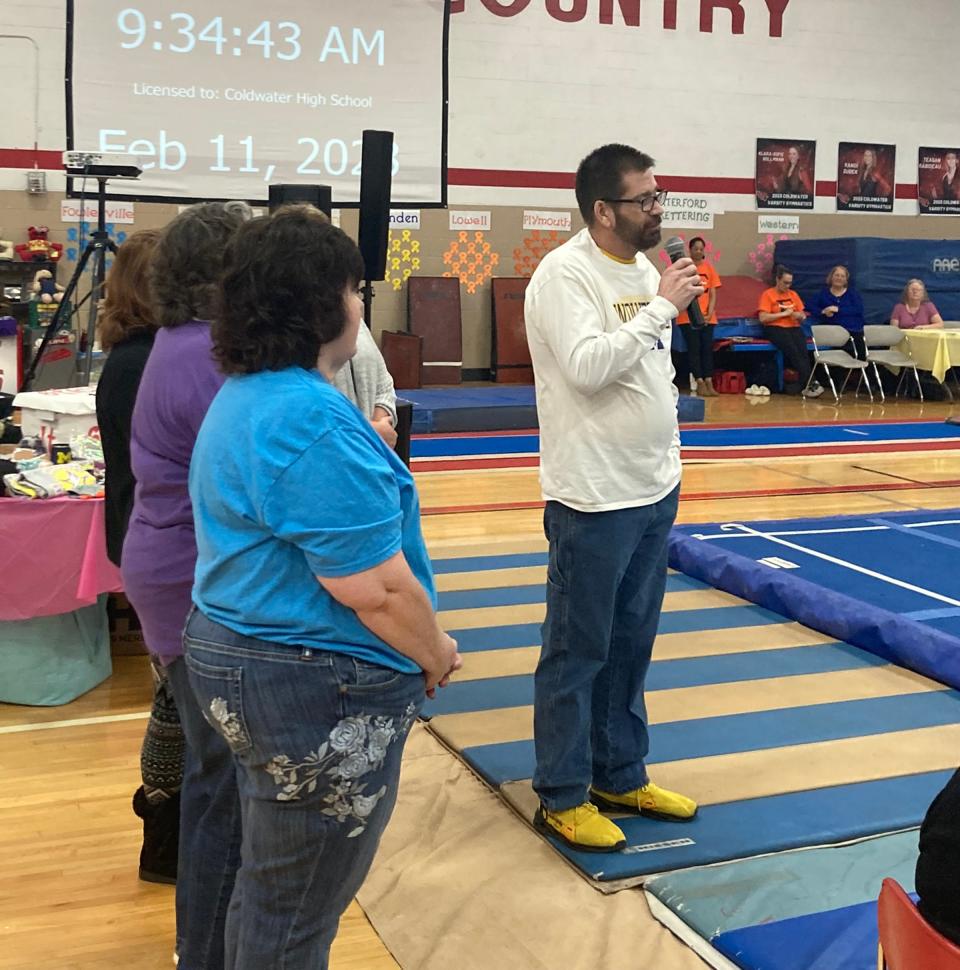 Special guest speaker Michael Cole shares his story with those in attendance at Saturday's 13th annual Stick It for a Cure Gymnastics Invite.