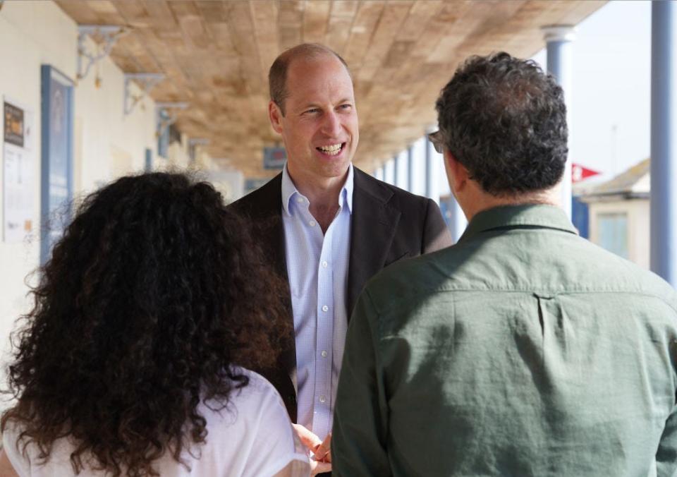 Prince William speaks to two people in Sicily, Italy, in May 2024.