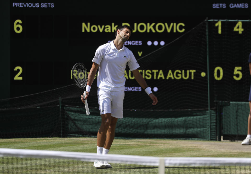 Serbia's Novak Djokovic reacts after losing a point to Spain's Roberto Bautista Agut in a Men's singles semifinal match on day eleven of the Wimbledon Tennis Championships in London, Friday, July 12, 2019. (AP Photo/Kirsty Wigglesworth)