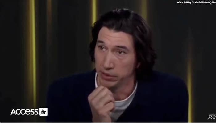 Adam Driver during an interview, wearing a dark jacket over a white shirt, with his hand rested near his chin. "Access" logo in the corner