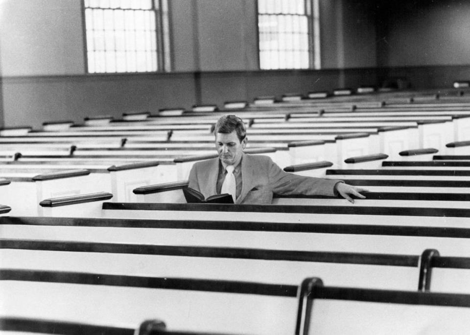 The Rev. Robert Meneilly in the pews at Village Presbyterian Church.