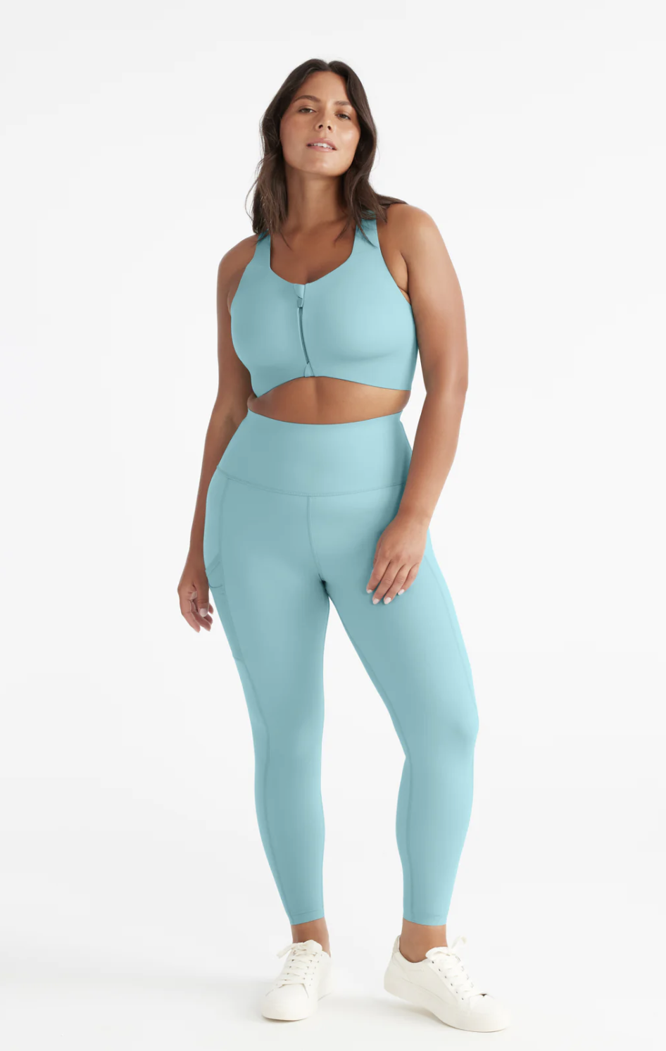 model wearing light blue sports bra and light blue Stashable High Rise Legging (photo via Knix)