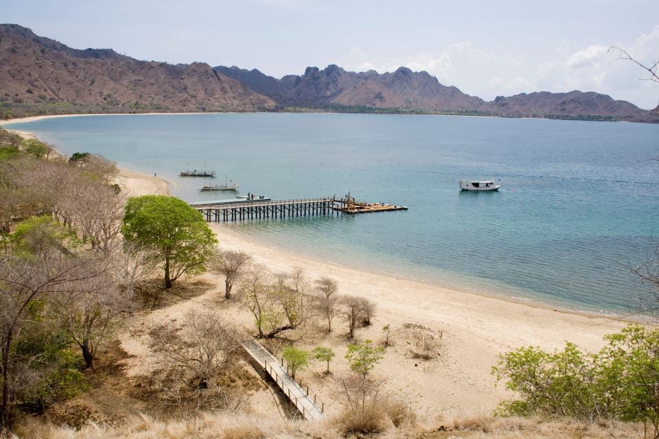 This undated photo provided by researcher Bryan Fry shows a beach at Komodo National Park in Indonesia. Encompassing about 850 square miles (2,200 square kilometers) of land and marine area, Komodo National Park was established in 1980 to help protect the famed dragons. Indonesia's Ministry of Environment and Forestry estimates around 3,000 of the reptiles live there today, along with manatee-like dugongs, sea turtles, whales and more than a thousand species of tropical fish. (Bryan Fry via AP)