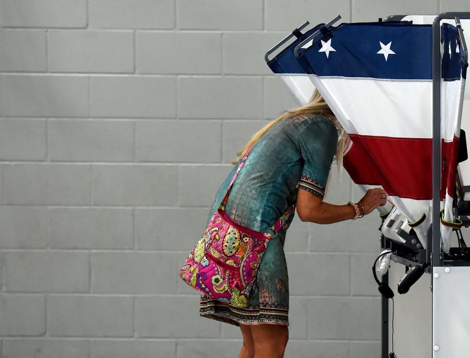 Kym Kuhns makes her selection as she casts her ballot in the primary election at the Sylvan Park Elementary School polling place in Nashville, Tennessee on Thursday, August 1, 2024.