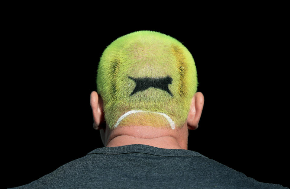 A tennis fan with his hair dyed the colour of a Slazenger ball on day one of the Wimbledon Tennis Championships in London, Monday July 1, 2019. (Mike Egerton/PA via AP)