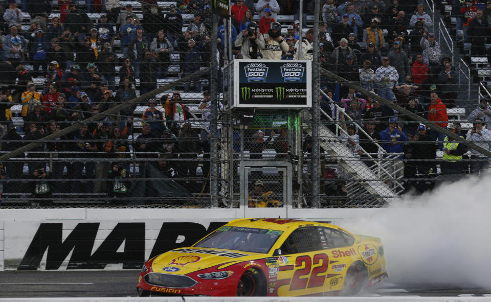 Joey Logano (22) does a burnout as he celebrates after winning the Monster Energy NASCAR Cup Series auto race at Martinsville Speedway in Martinsville, Va., Sunday, Oct. 28, 2018. (AP Photo/Steve Helber)