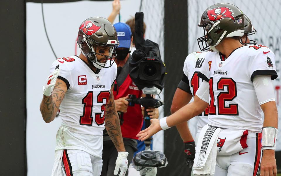 Tampa Bay Buccaneers wide receiver Mike Evans (13) celebrates a touchdown with quarterback Tom Brady (12) against the Los Angeles Chargers in the second quarter of a NFL game at Raymond James Stadium - Kim Klement-USA TODAY Sports