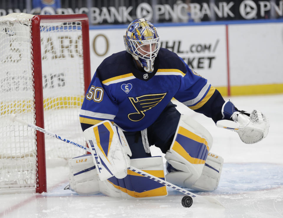 St. Louis Blues goaltender Jordan Binnington deflects a shot during the first period of the team's NHL hockey game against the Minnesota Wild, Thursday, May 13, 2021 in St. Louis. (AP Photo/Tom Gannam)