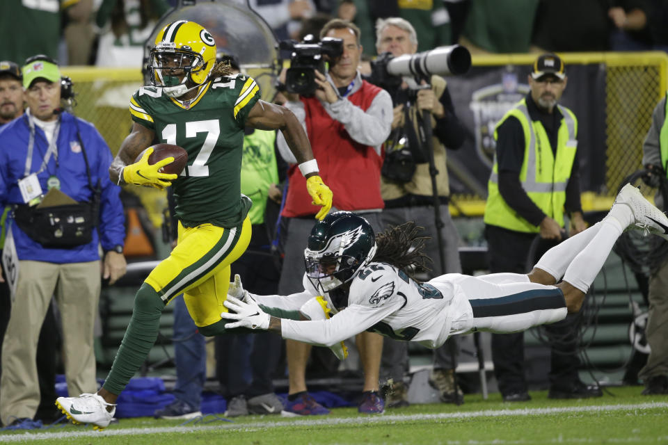 Green Bay Packers wide receiver Davante Adams runs from the defense of Philadelphia Eagles cornerback Sidney Jones after making a catch during the first half of an NFL football game Thursday, Sept. 26, 2019, in Green Bay, Wis. (AP Photo/Jeffrey Phelps)