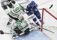 Dallas Stars goaltender Anton Khudobin (35) makes a save against Tampa Bay Lightning center Anthony Cirelli (71) as Stars' Tyler Seguin (91) defends during second-period NHL Stanley Cup finals hockey action in Edmonton, Alberta, Saturday, Sept. 19, 2020. (Jason Franson/The Canadian Press via AP)