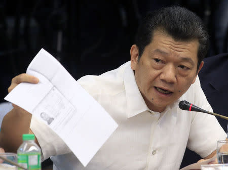 Chinese-born Filipino businessman Kam Sin Wong presents a document during the money laundering hearing at Senate in Manila March 29, 2016. REUTERS/Romeo Ranoco