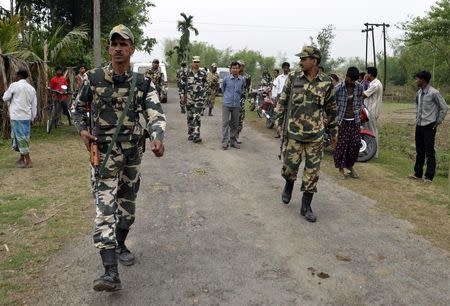 Indian security personnel patrol the attack-hit area of the Balapara village in the northeastern Indian state of Assam May 2, 2014. REUTERS/Stringer