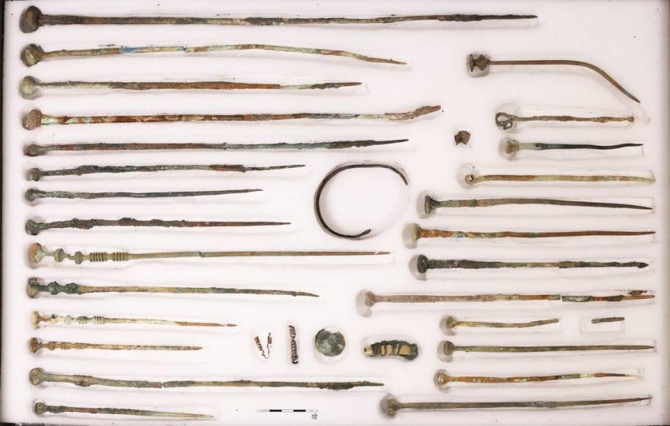 Bronze needles or robe pins found at the bottom of the well.