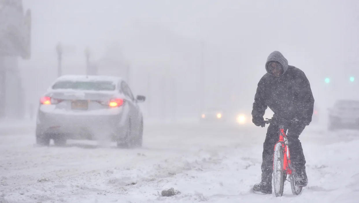 A cyclist struggles in a winter storm in Utica, N.Y., in January 2016. Heavy lake-effect snow and cold temperatures are expected across the Great Lakes through Wednesday. Mark DiOrio, Observer-Dispatch V