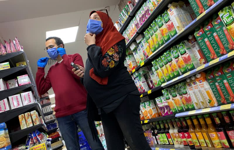 A family with protective masks is seen at a market in Cairo