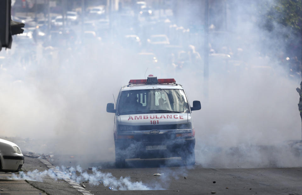 <p>A Palestinian ambulance emerges from a cloud of tear gas during clashes with Israeli forces after a rally to mark the 70th anniversary of what Palestinians call their “nakba,” or catastrophe — the uprooting of hundreds of thousands in the Mideast war over Israel’s 1948 creation, in the West Bank city of Bethlehem, Tuesday, May 15, 2018. (Photo: Majdi Mohammed/AP) </p>