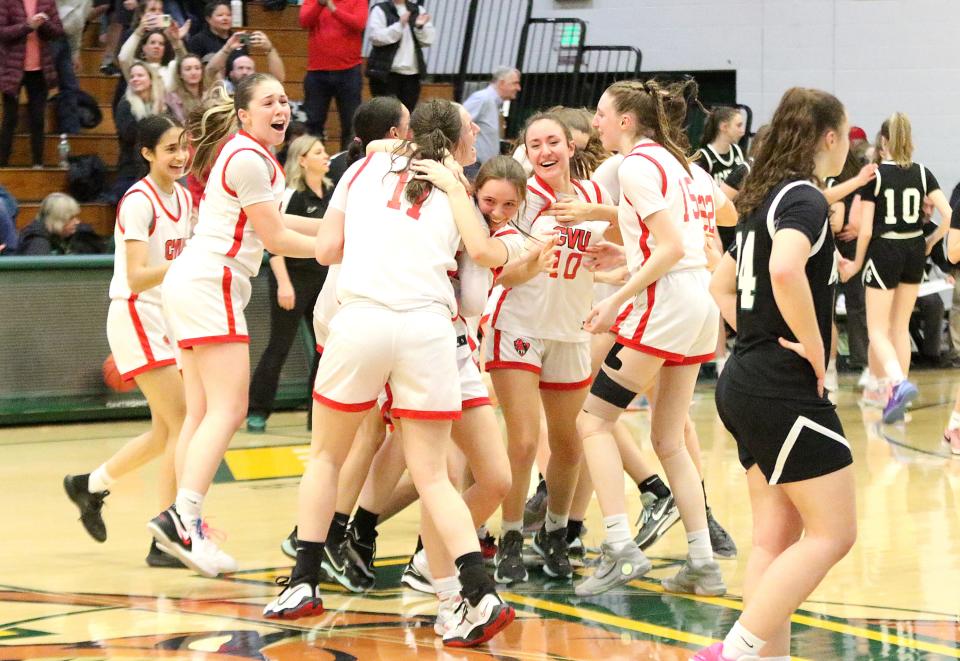 The Redhawks storm the court after CVU's 38-33 win over St. Johnsbury the D1 State Championship game on Wednesday night at UVM's Patrick Gym.