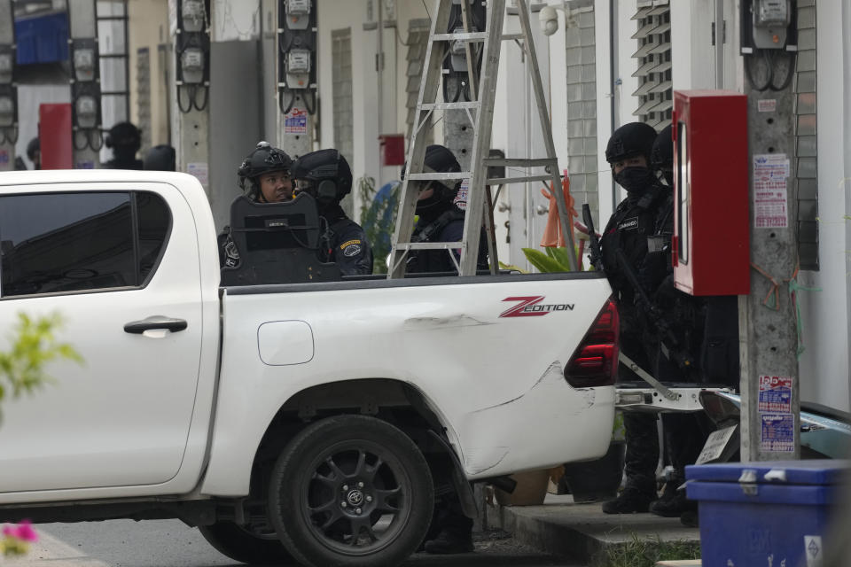 A group of armed commando police are seen outside the home of a senior police officer in Bangkok, Thailand, Wednesday, March 15, 2023. Thai police have arrested a fellow officer who fired multiple gunshots from his home in Bangkok which forced an over 24 hours-long standoff after his colleagues tried to take him to be treated for mental illness. (AP Photo/Sakchai Lalit)