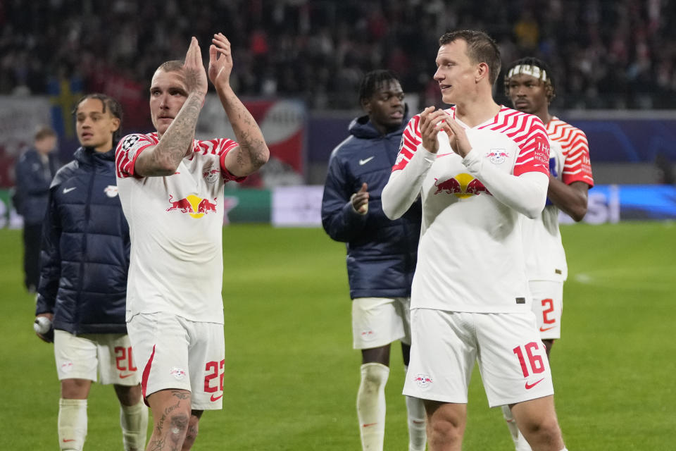 Leipzig players greet supporters after the group G Champions League soccer match between RB Leipzig and Red Star Belgrade at the Red Bull arena stadium in Leipzig, Germany, Wednesday, Oct. 25, 2023. (AP Photo/Matthias Schrader)