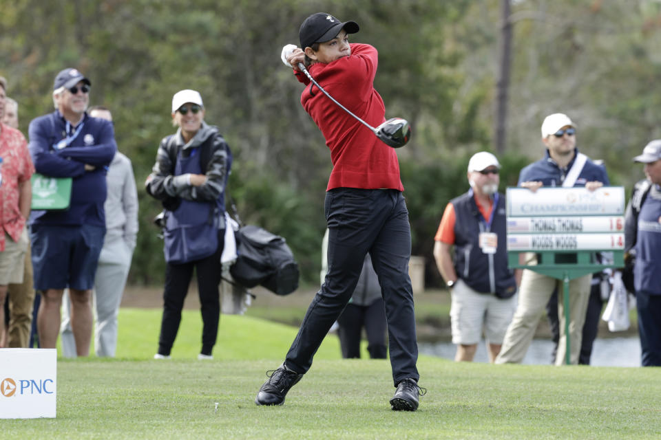 Charlie Woods tees off on the 3rd hole during the final round of the PNC Championship golf tournament Sunday, Dec. 18, 2022, in Orlando, Fla. (AP Photo/Kevin Kolczynski)