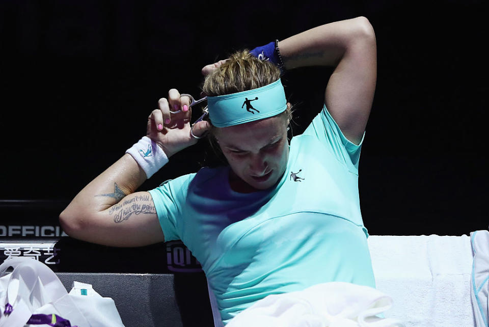 Tennis pro Svetlana Kuznetsova did what she had to do to beat her opponent on Monday — she had to give herself a spontaneous, on-court haircut. (Photo: Getty)