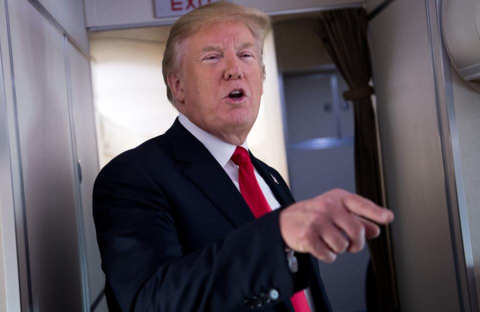 US President Donald Trump speaks to the press aboard Air Force One in flight as he travels from Joint Base Andrews in Maryland, to Bedminster, New Jersey, June 29, 2018. - Trump denied he is planning to withdraw the United States from the World Trade Organization. 'I'm not talking about pulling out,' he told reporters on Air Force One when asked about reports he was planning an exit from the global trading body. (Photo by SAUL LOEB / AFP)        (Photo credit should read SAUL LOEB/AFP/Getty Images)