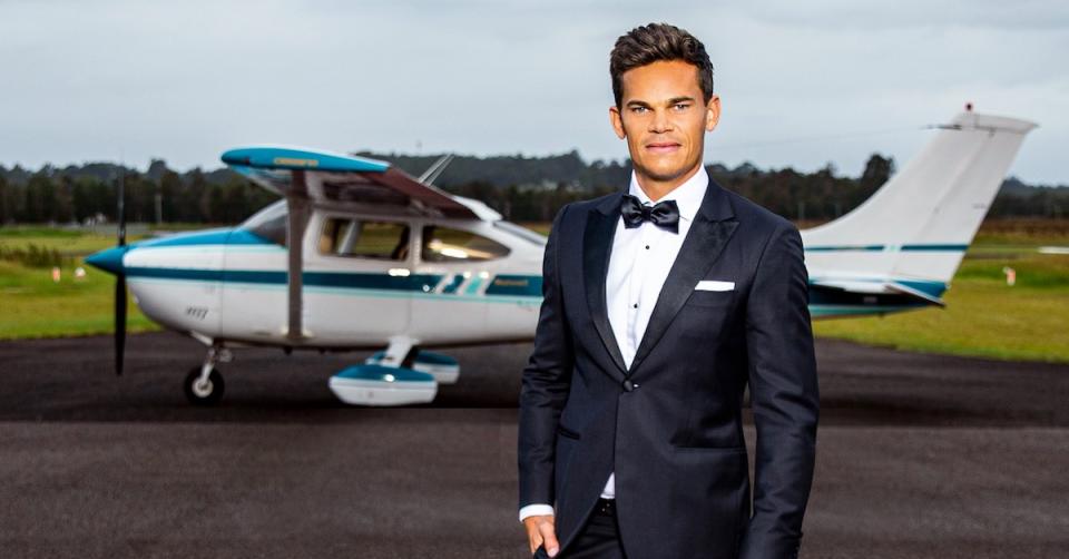 The Bachelor 2021 Jimmy Nicholson in front of a private plane.