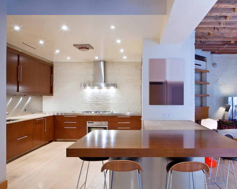 <p>We're loving the wooden finishes in the open-concept kitchen area, looking out to the living room. </p>