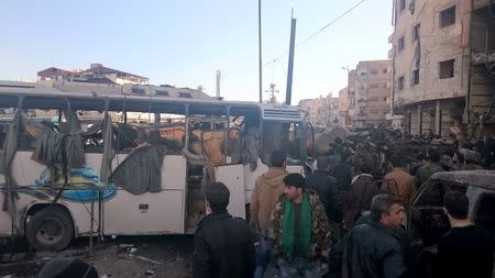 Residents and soldiers loyal to Syria's President Bashar al-Assad inspect damage after a suicide attack in Sayeda Zeinab, a district of southern Damascus, Syria January 31, 2016. REUTERS/Stringer