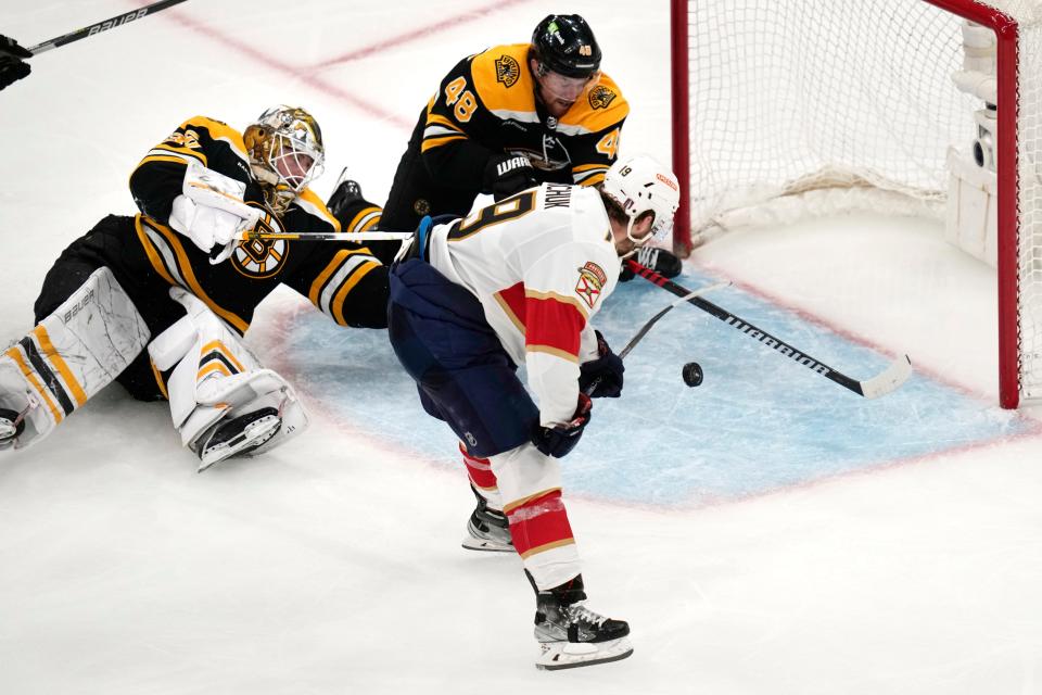 Florida Panthers left wing Matthew Tkachuk (19) shoots the puck past Boston Bruins goaltender Linus Ullmark and defenseman Matt Grzelcyk (48) while scoring the game-winning goal during overtime of Game 5 in the first round of the NHL hockey playoffs, Wednesday, April 26, 2023, in Boston. (AP Photo/Charles Krupa)